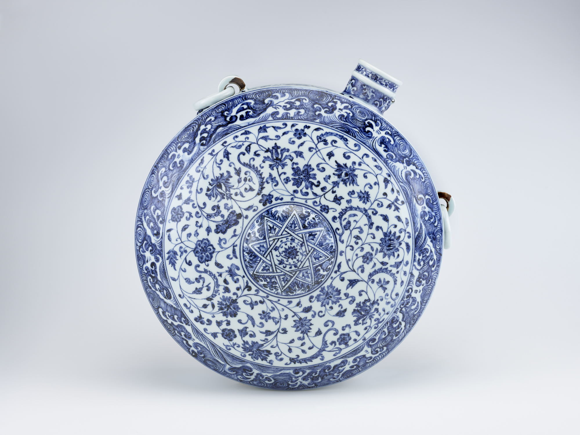 blue and white ceramic round vessel